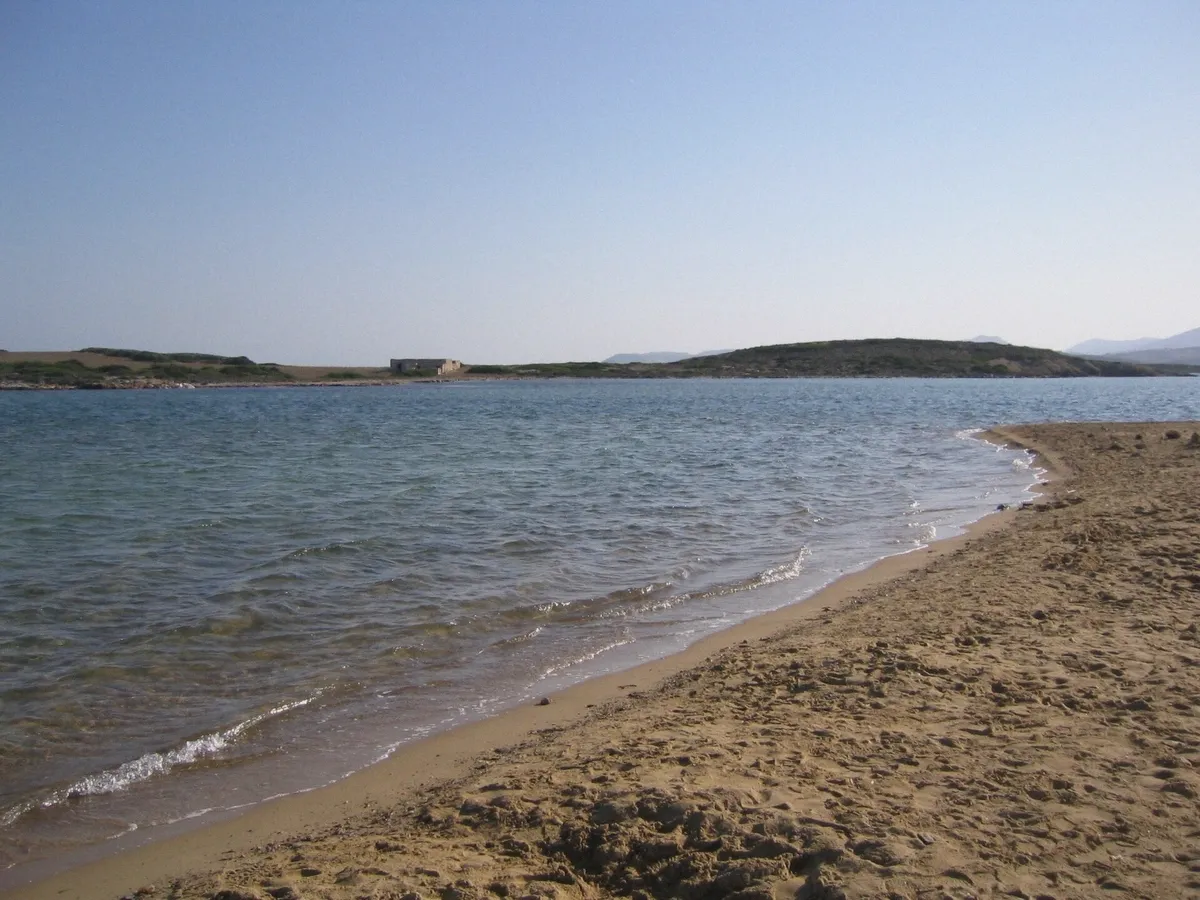 Sandy beach and clear water on Antiparos island reached on a boat trip from Paros