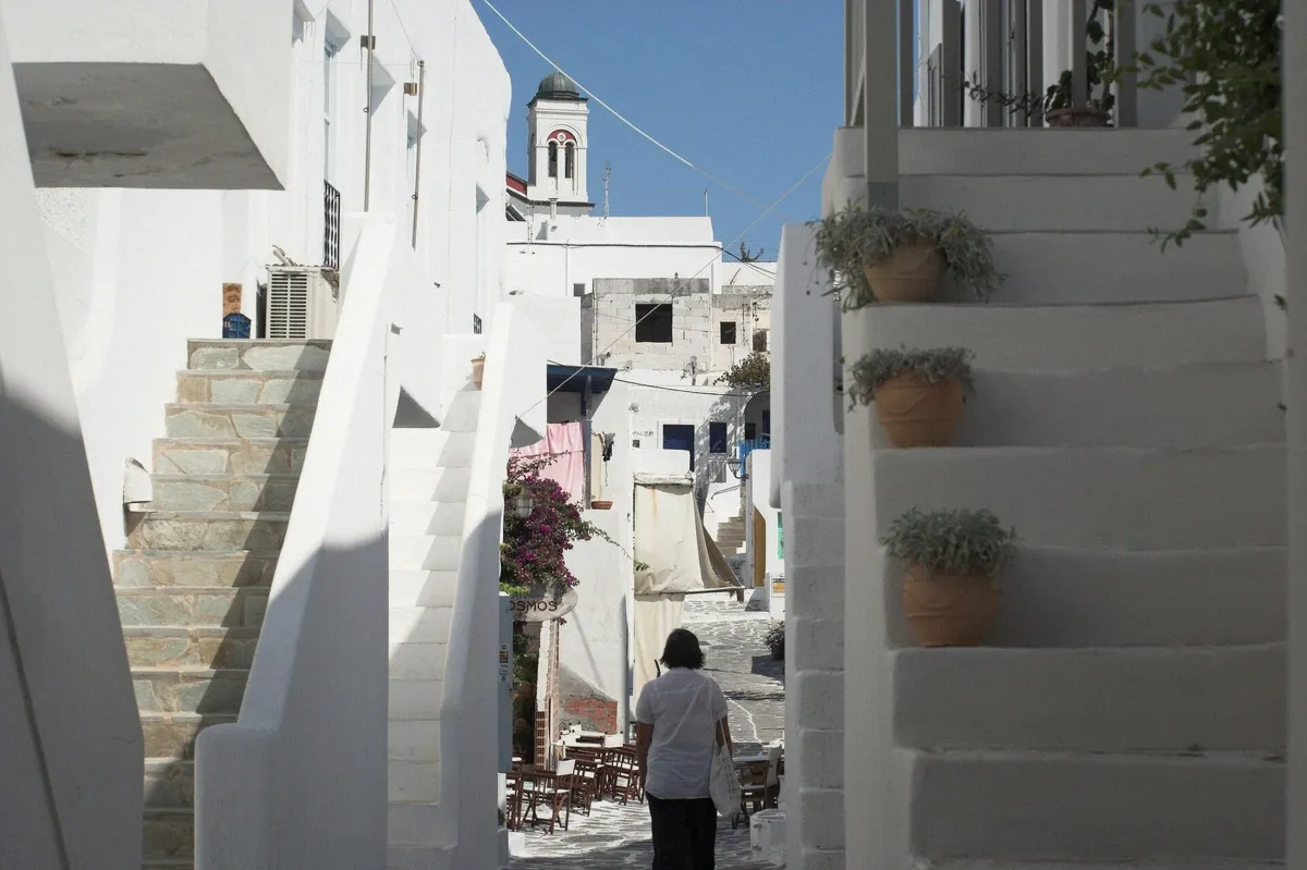 Whitewashed staircases of a Naoussa street in Paros in the evening light