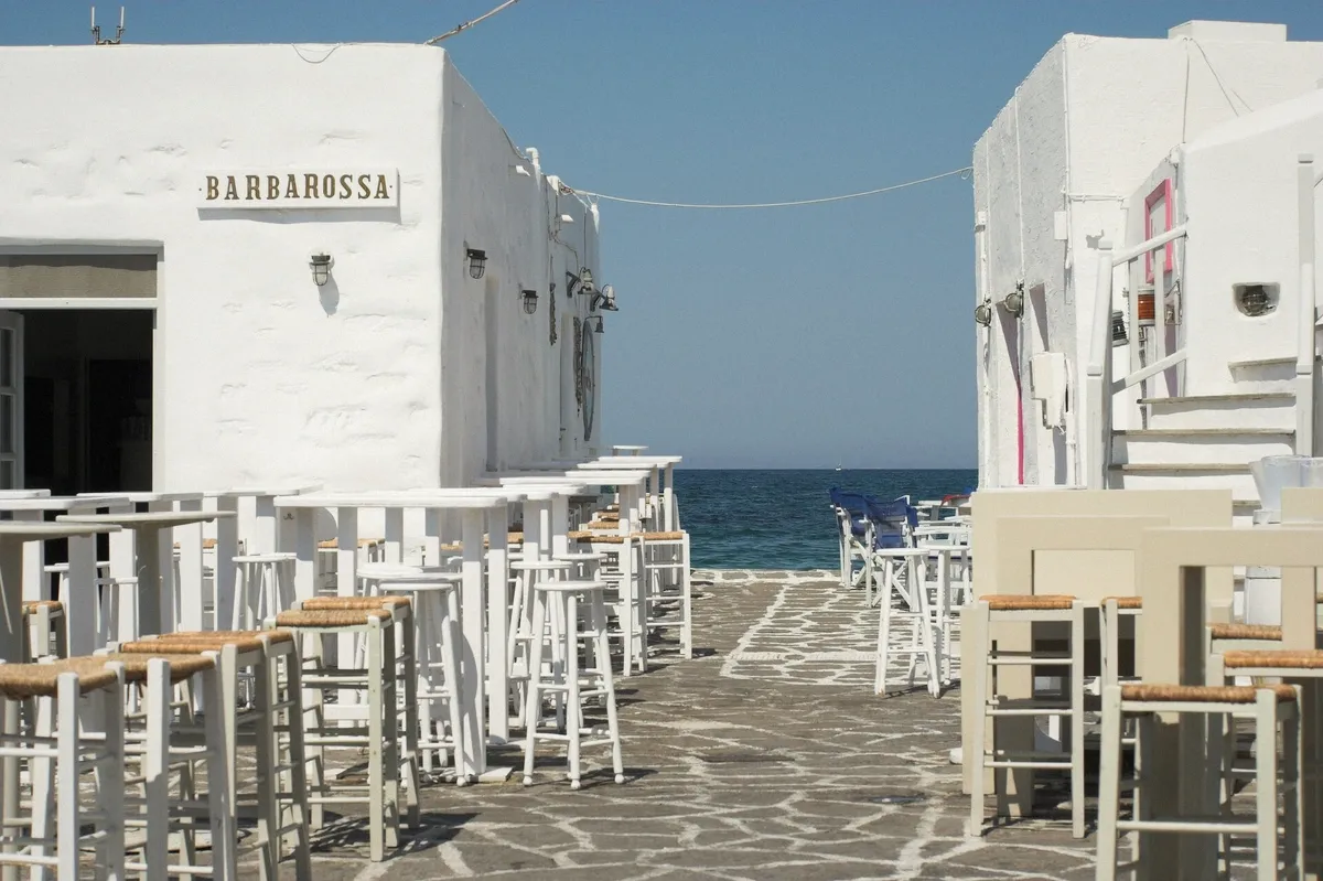 Fish tavern tables by the harbour of Naoussa, Paros, after a boat day