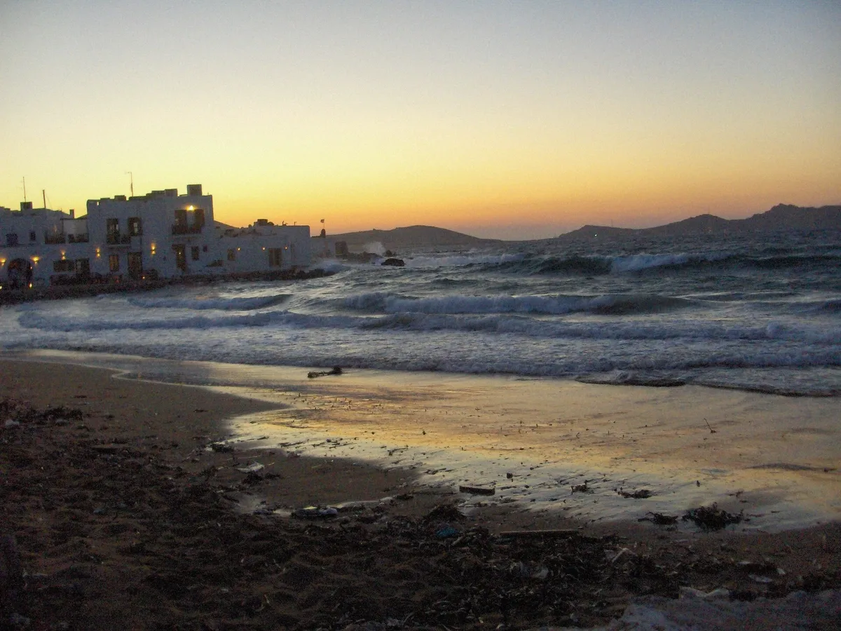Sunset over Naoussa in Paros seen from the water on an evening boat trip