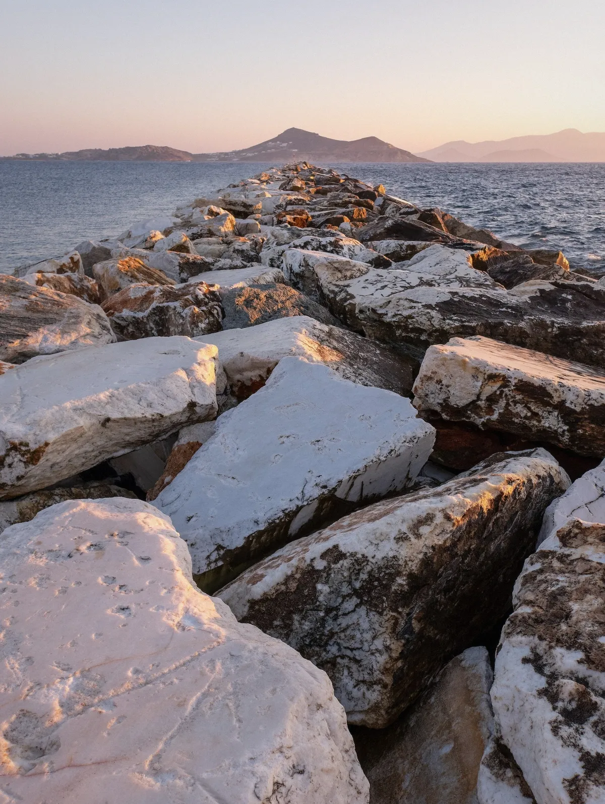 View from the Antiparos breakwater toward Paros at sunset