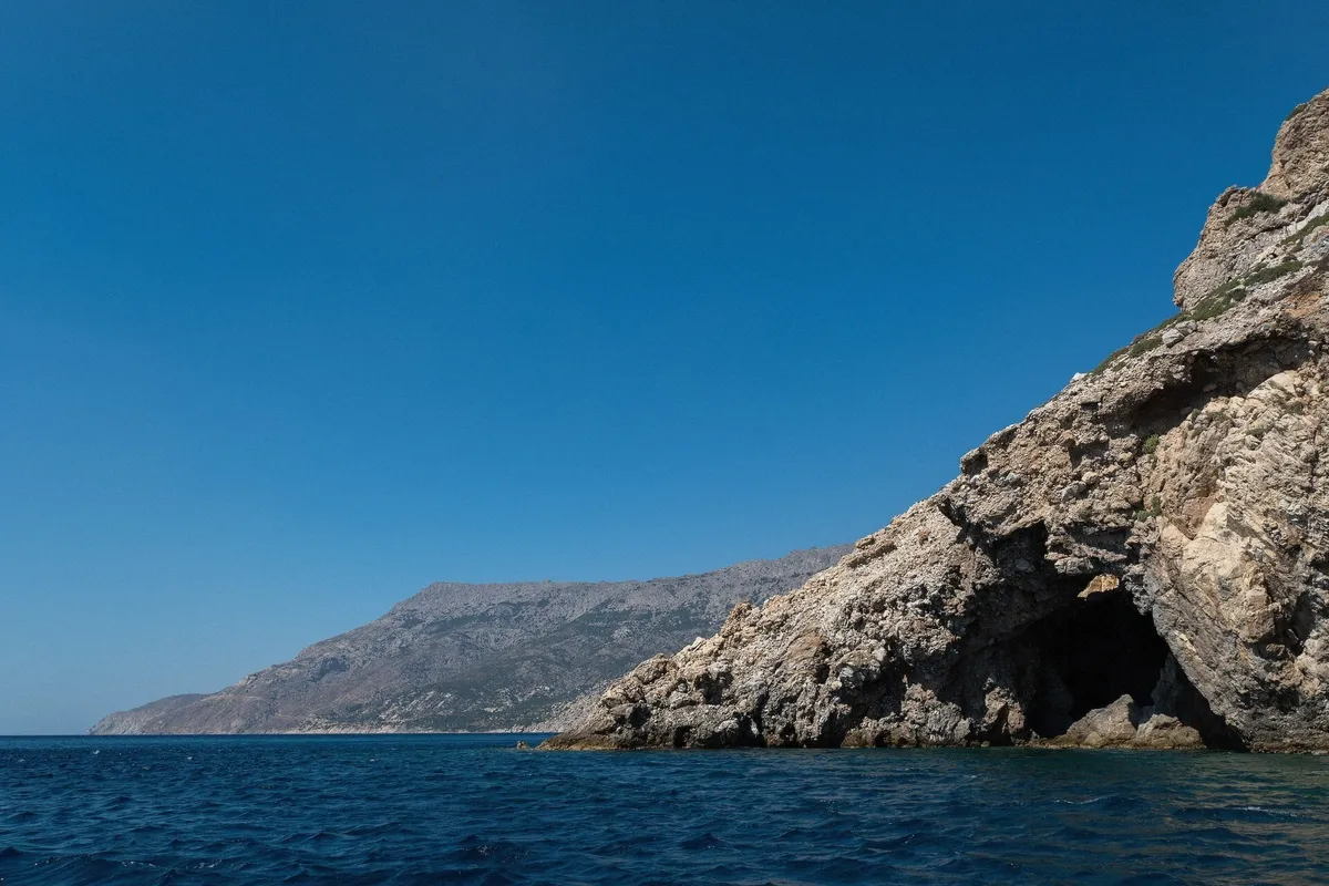 Limestone sea cave seen from a boat in the Aegean, similar to the Antiparos caves
