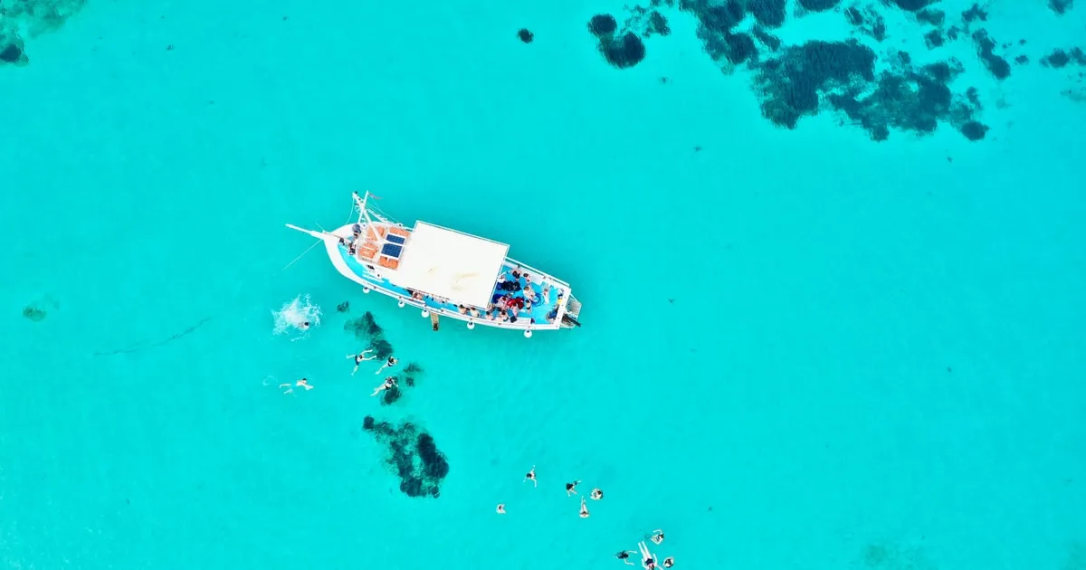 Clear turquoise water over pale sand in the Blue Lagoon near Antiparos on a Paros half-day boat tour